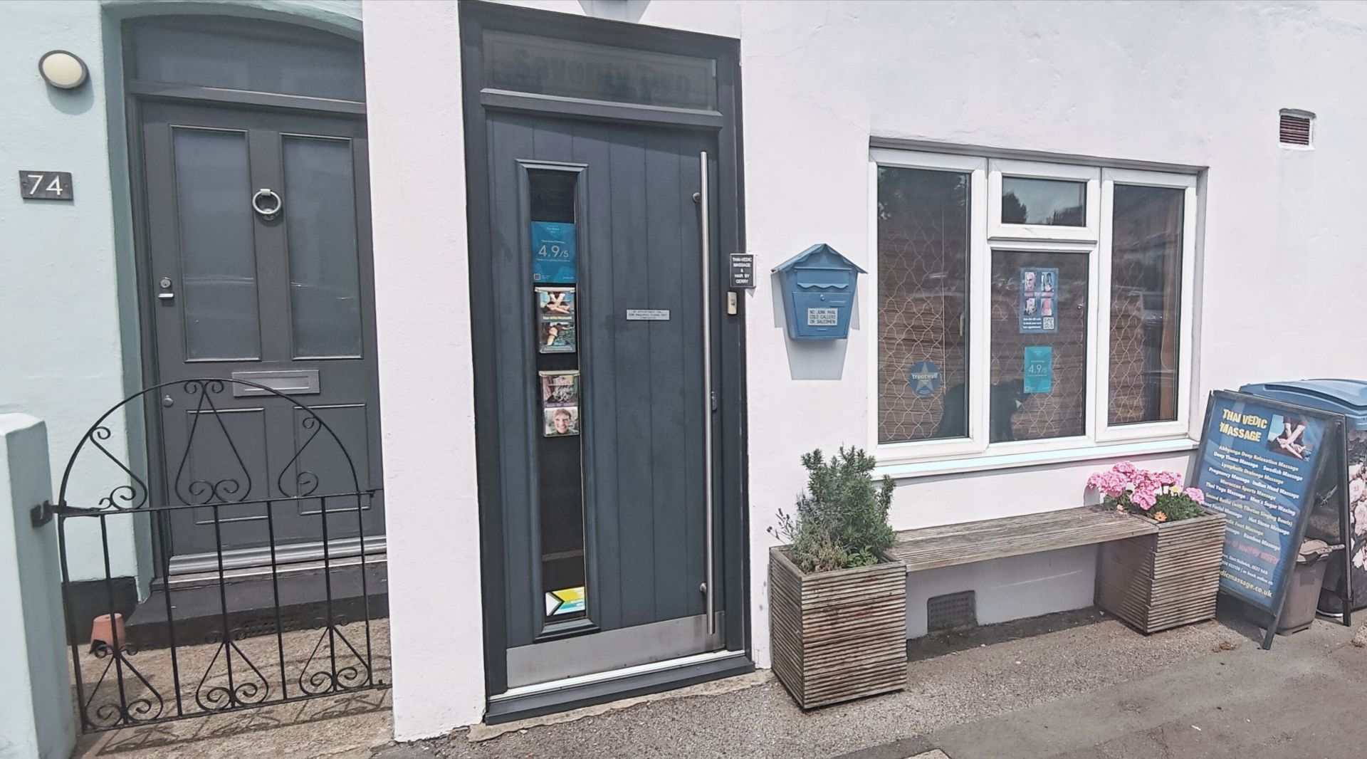 The pink and teal shopfront of Hair by Gerry's studio on Crawthew Grove, East Dulwich